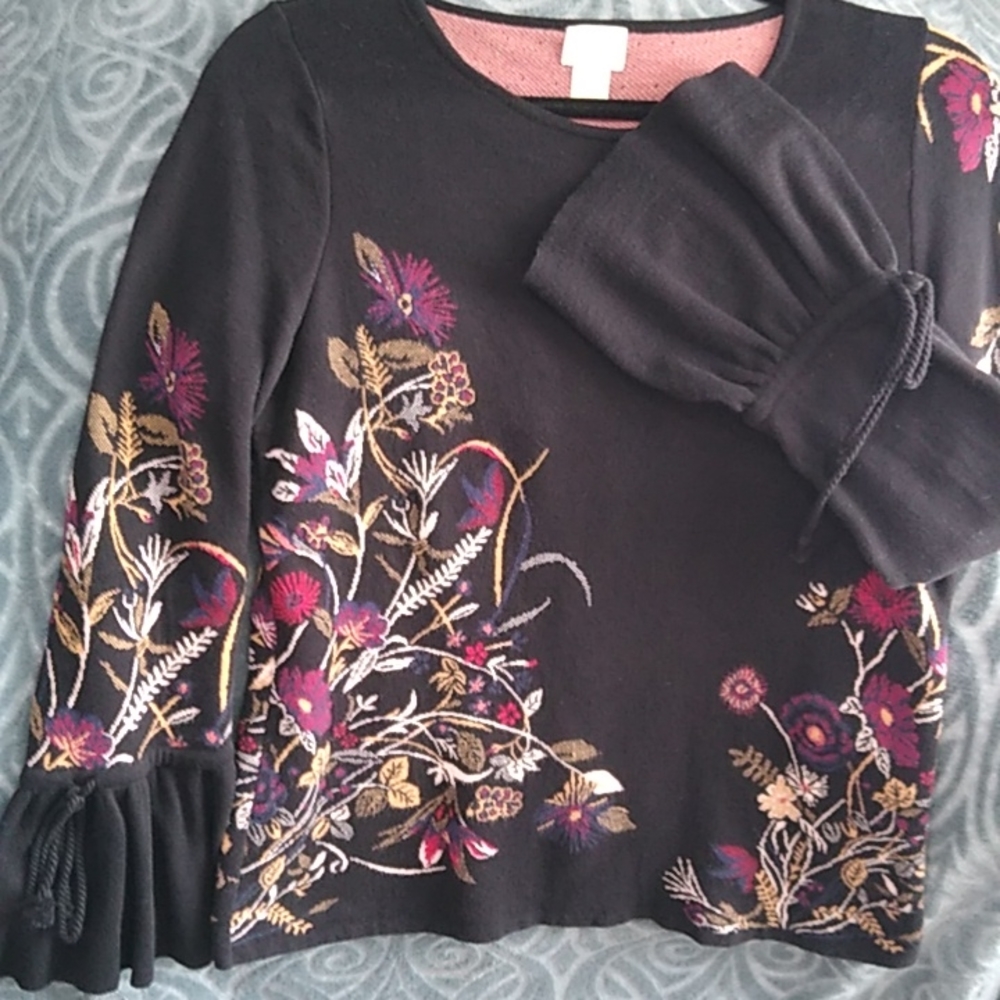 Chico's Sweater with Bell Sleeves and Floral Design on a Black background.